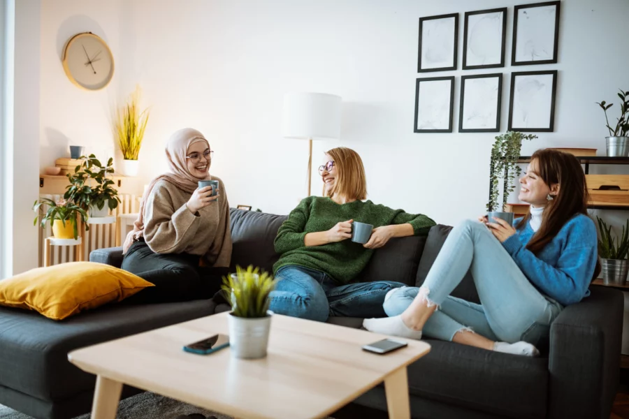 Three women talking on a sofa
